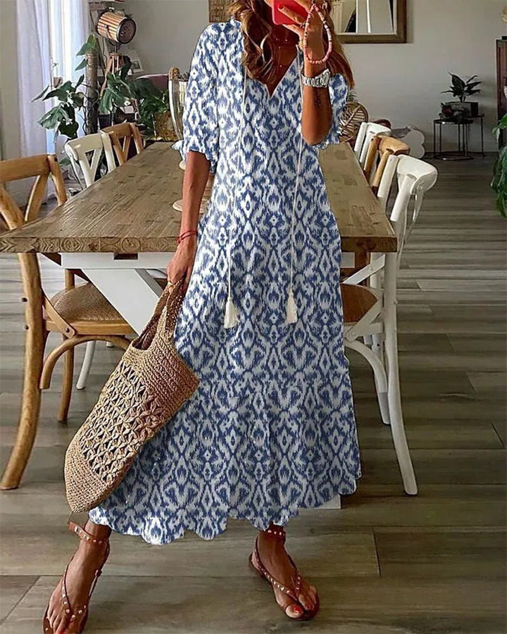 A printed boho vintage V-neck maxi dress with a flowing relaxed silhouette.