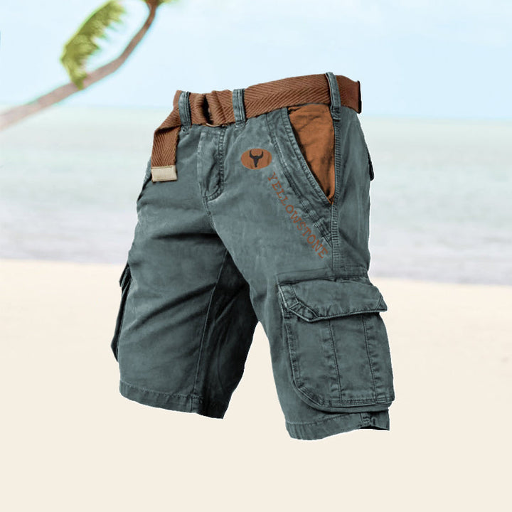  Male model displaying relaxed cargo shorts with practical pocket details on a plain background.