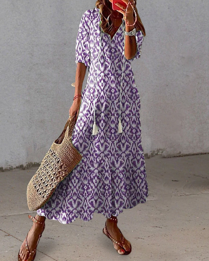 Vintage-inspired V-neck dress with a feminine flowing fit.