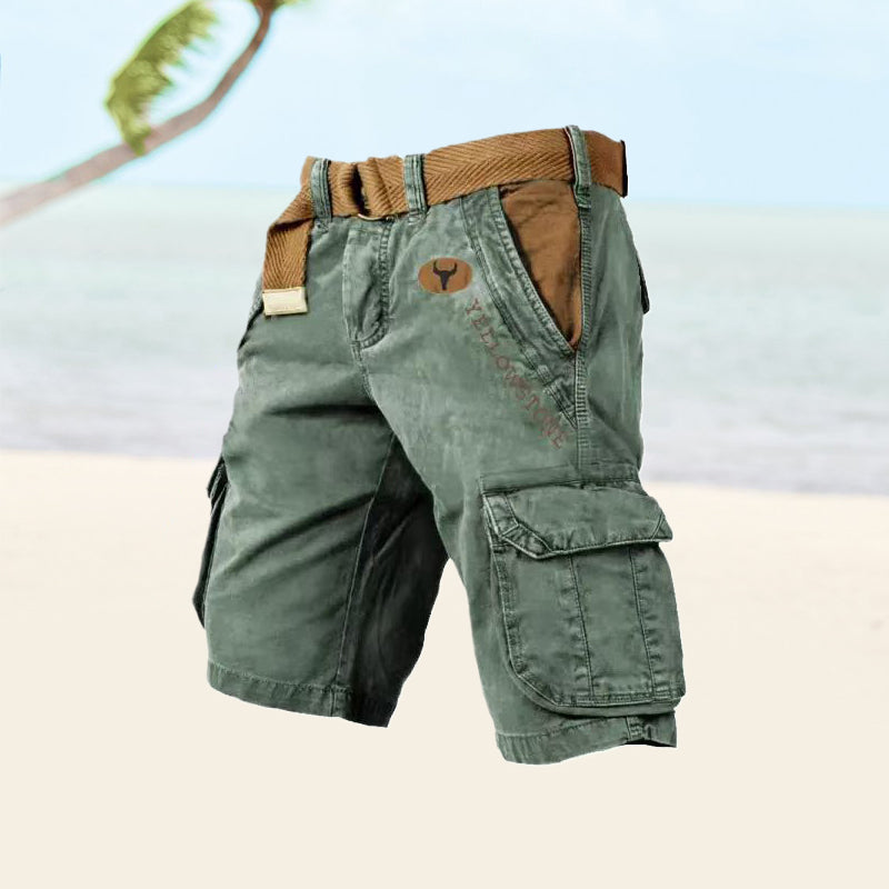  Male model wearing outdoor-inspired cargo shorts with a belt on a plain background.