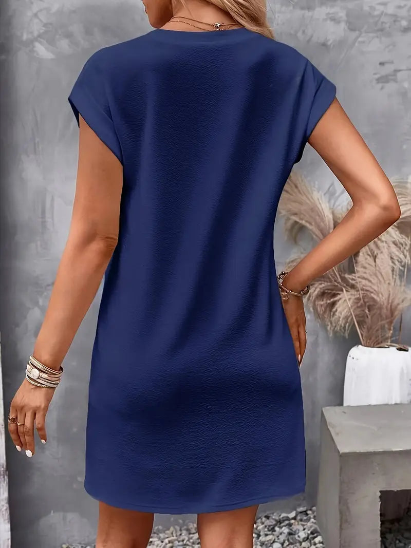  Woman showcasing a lightweight tunic dress with a defined waist on a plain background.