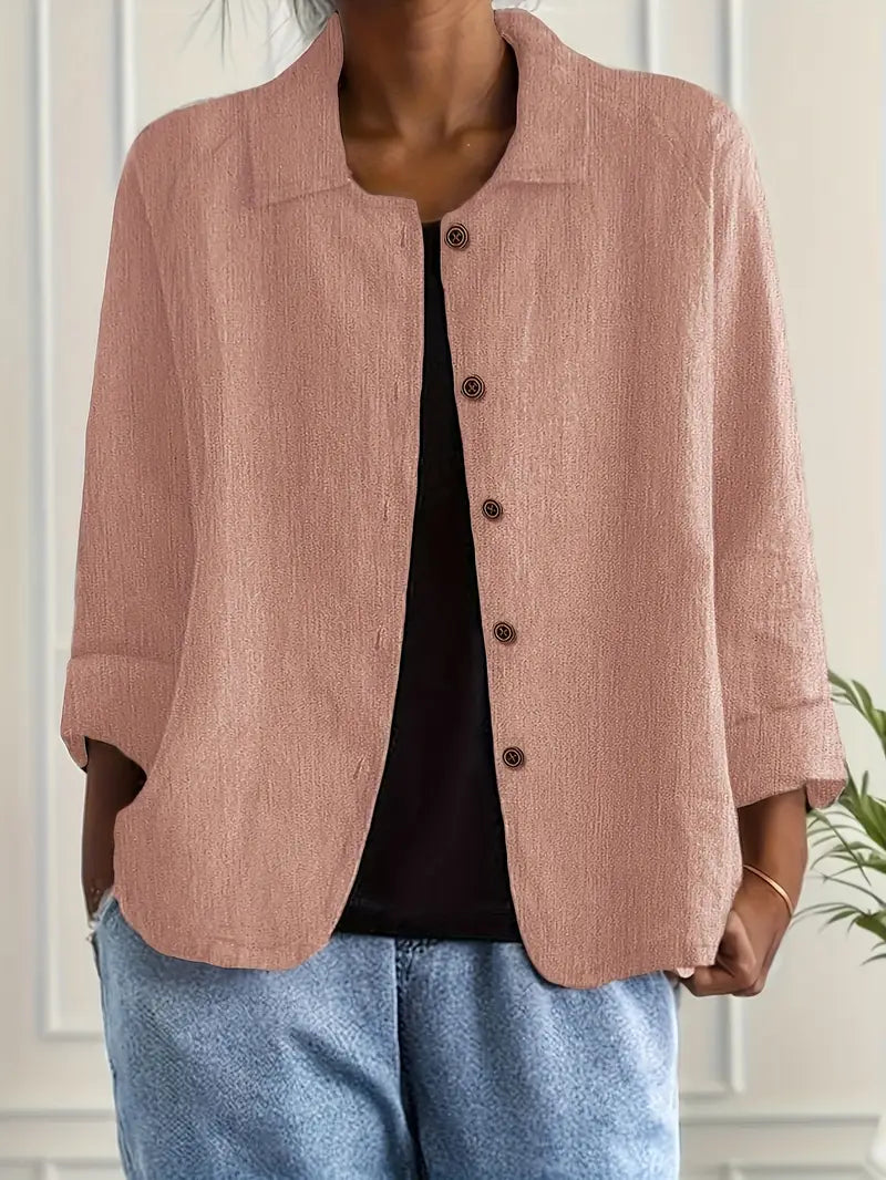 Elegant women’s top styled on a plain background with breathable fabric and graceful drape.