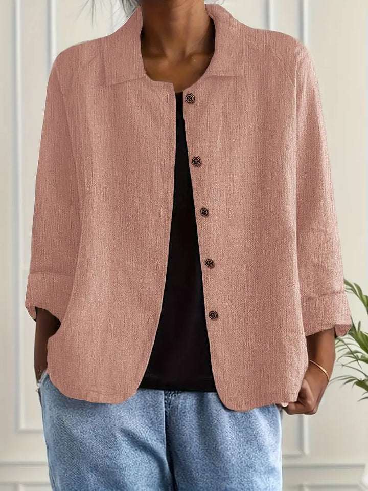 Elegant women’s top styled on a plain background with breathable fabric and graceful drape.