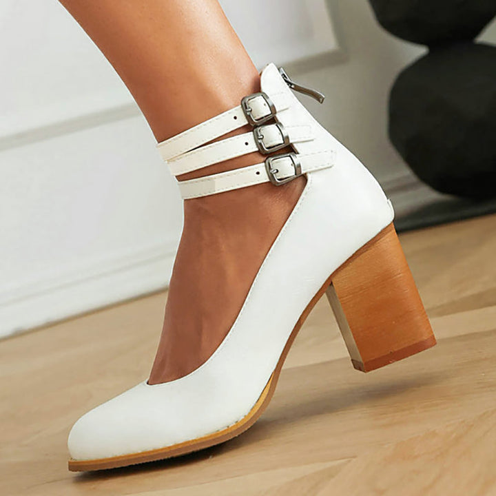 Foot wearing a timeless ankle strap sandal with a balanced heel.