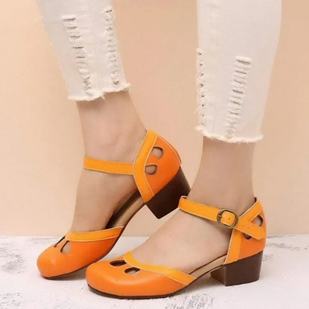 Foot shown in supportive low-heel sandal on a clean background.