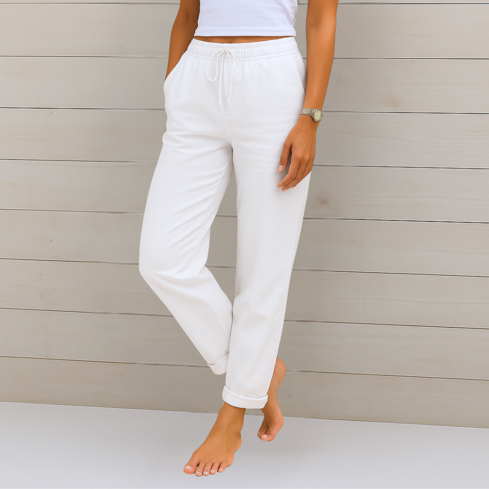 Female model wearing relaxed fit pants with a clean background.