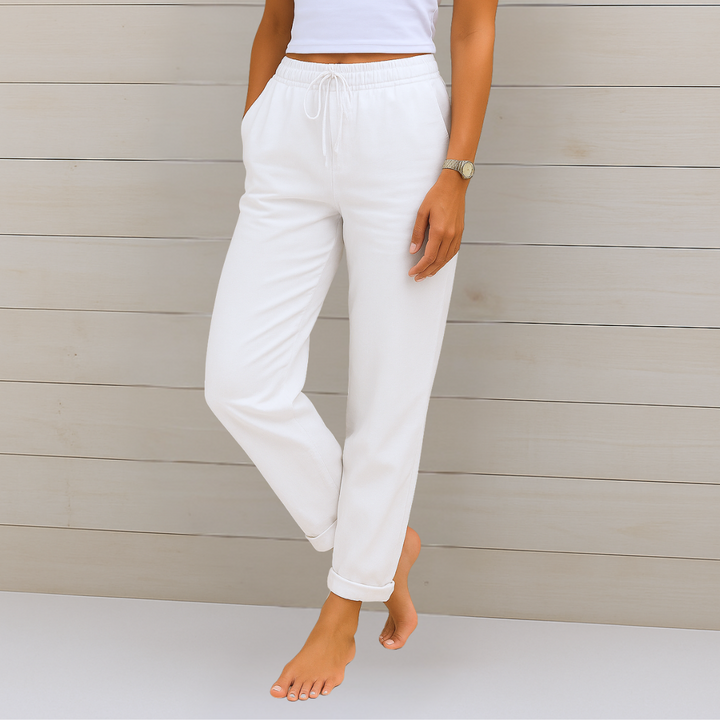 Female model wearing relaxed fit pants with a clean background.