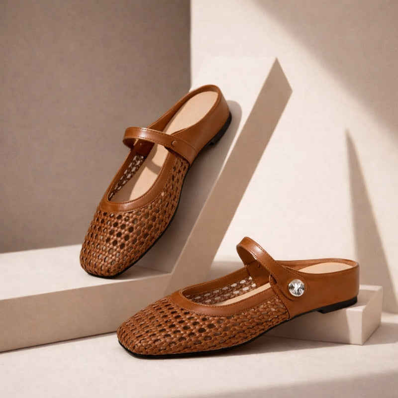 Model wearing metallic finish woven mules with square toe shape on a plain background.