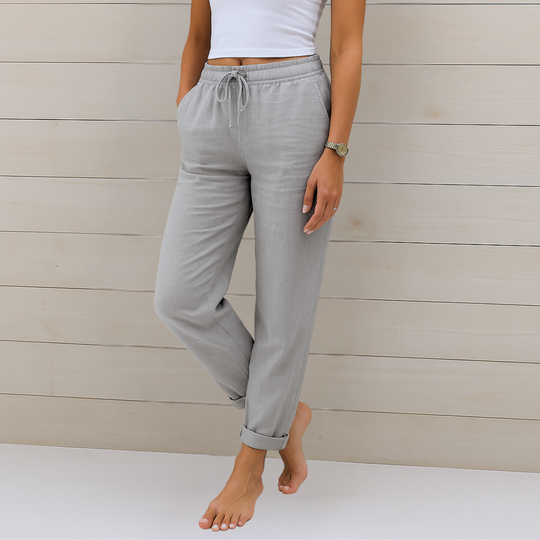 Woman wearing soft drape casual pants on a plain background.