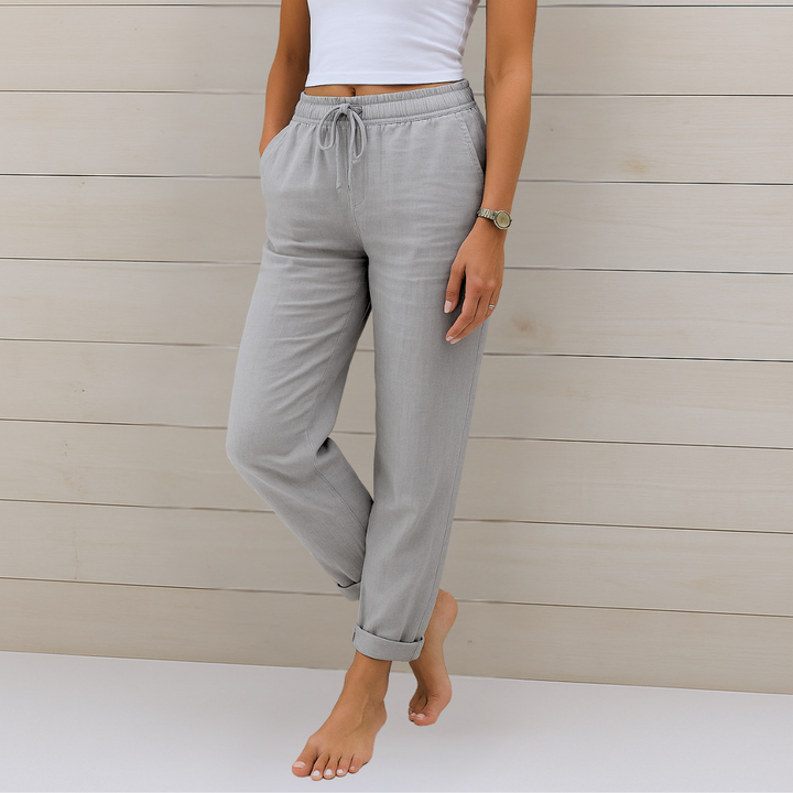 Woman wearing soft drape casual pants on a plain background.