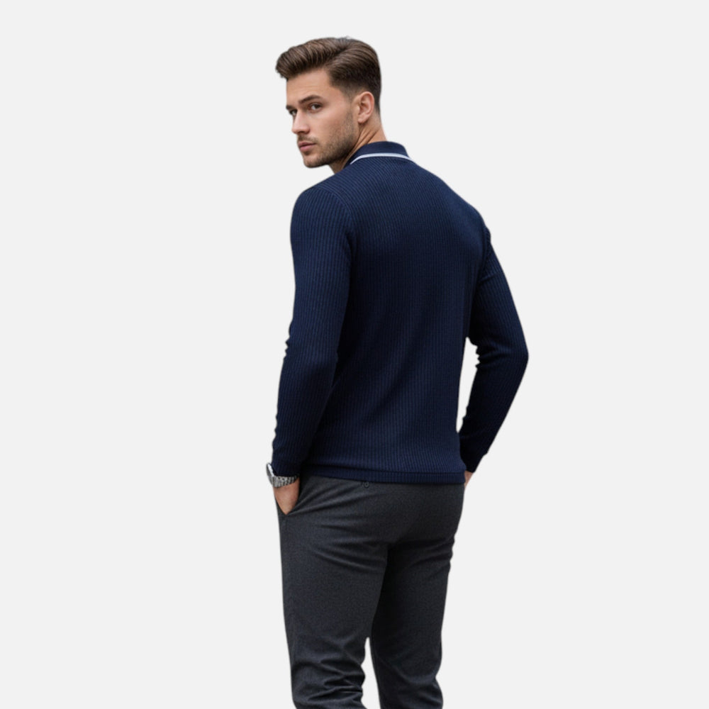  Male model showcasing a navy collared shirt with contrast accents on a plain background.