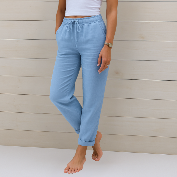 Woman styled in lightweight elastic waist trousers on a plain background.