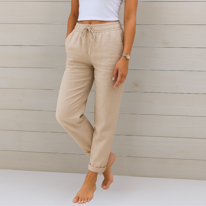 Woman wearing breathable elastic waist pants on a plain background.