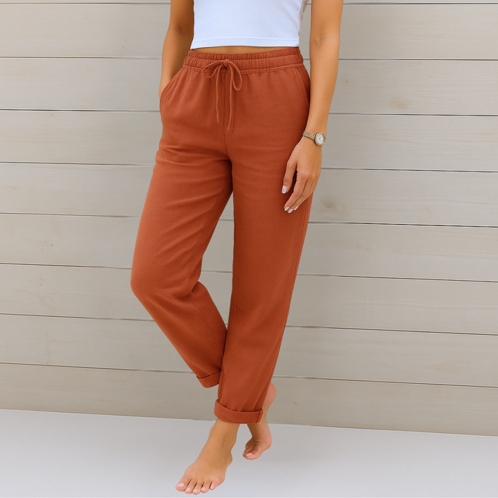 Female model in comfortable stretch waist pants with a clean background.
