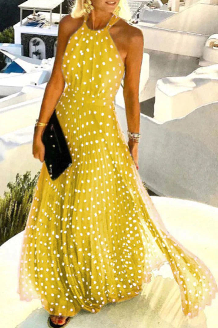 Female styled in a lightweight halter neckline maxi dress with a flowing fit against a plain background.