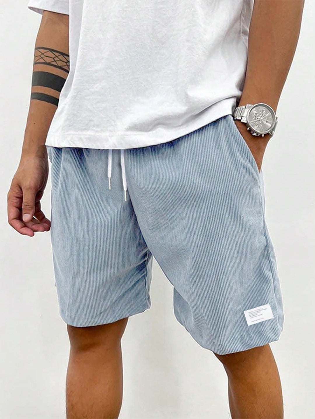  Male model in casual drawstring waist shorts against a plain background