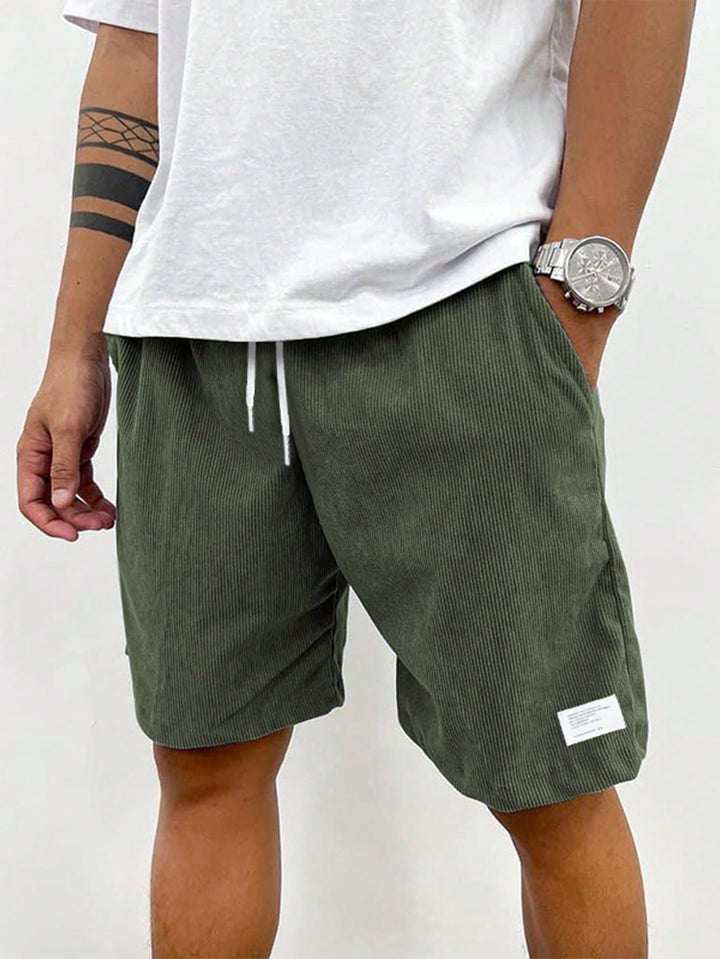  Male model wearing warm-weather shorts with a relaxed look on a plain background.