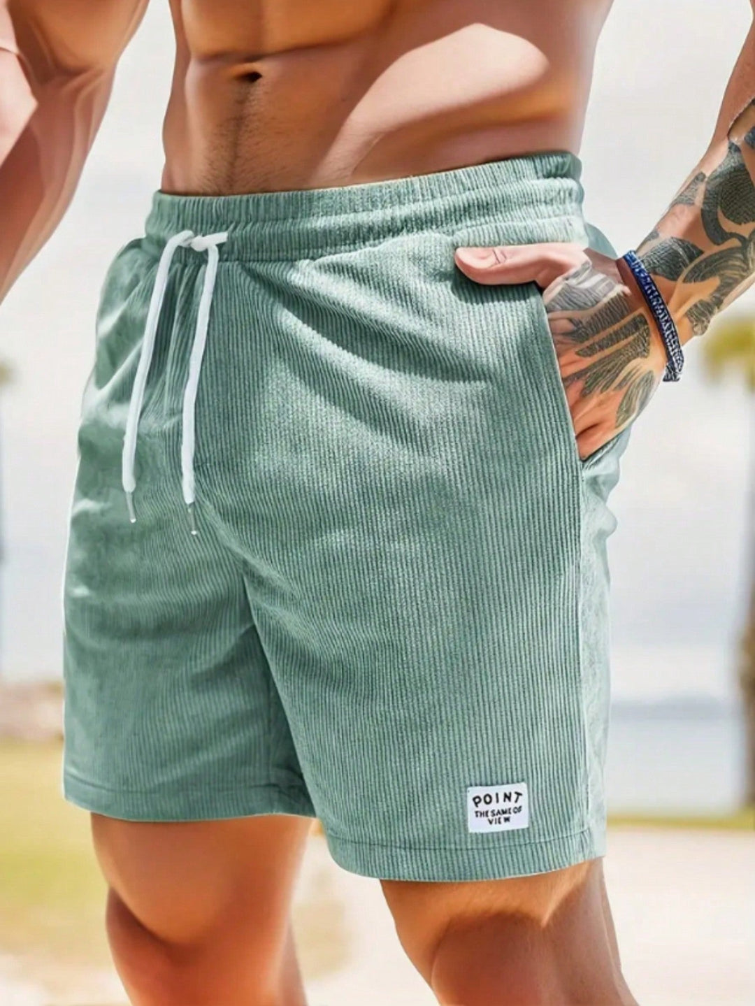  Male model in relaxed shorts with a simple outfit on a plain background.