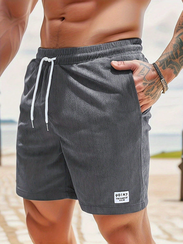  Male model wearing drawstring shorts with a clean casual look on a plain background.