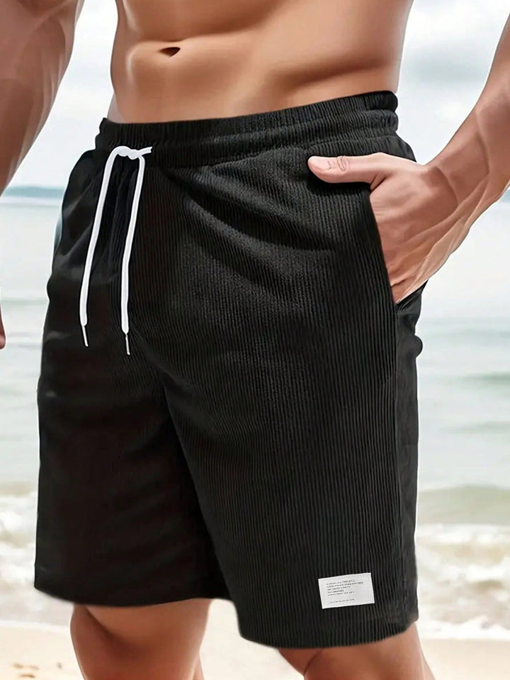  Male model in everyday casual shorts shown on a plain background.