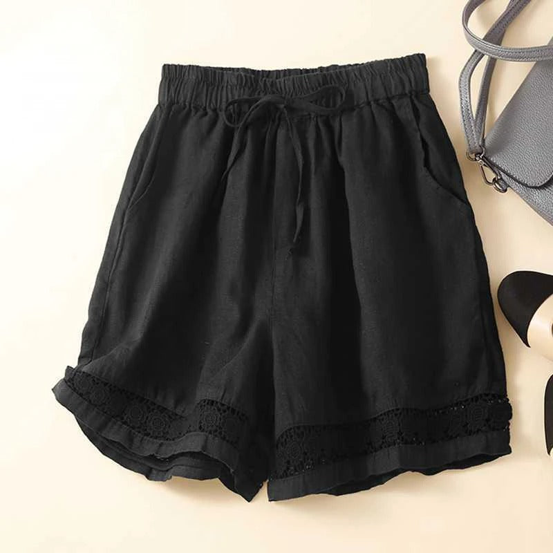 Breathable embroidered shorts displayed on a beige background.