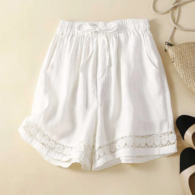 Women’s embroidered relaxed shorts on a beige background.