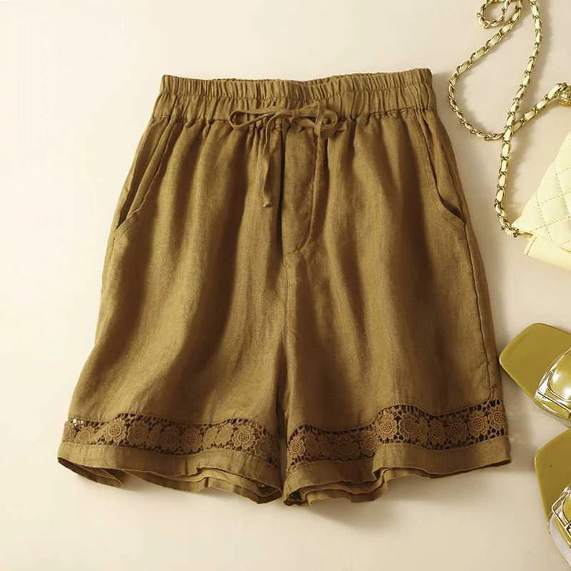Relaxed fit women’s shorts with stitched detail on beige background.