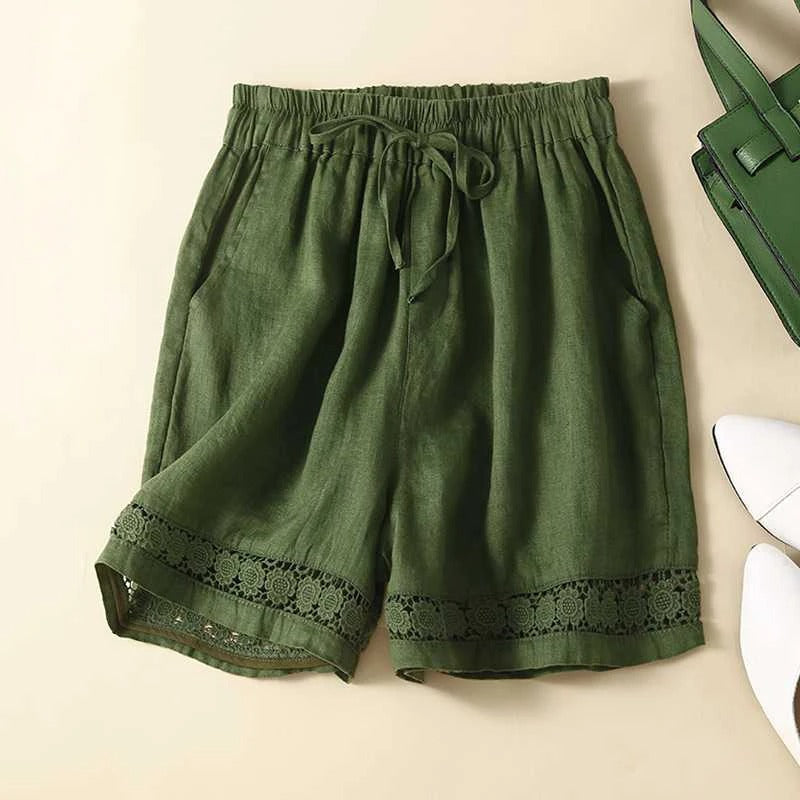 Casual women’s shorts with delicate embroidery on beige background.