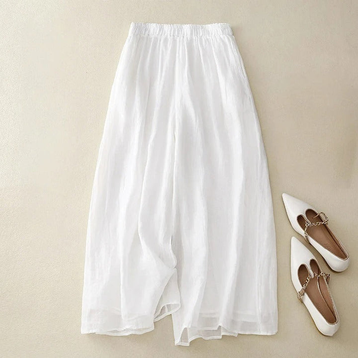 Chic wide-leg trousers with a comfortable waistband on a beige background.