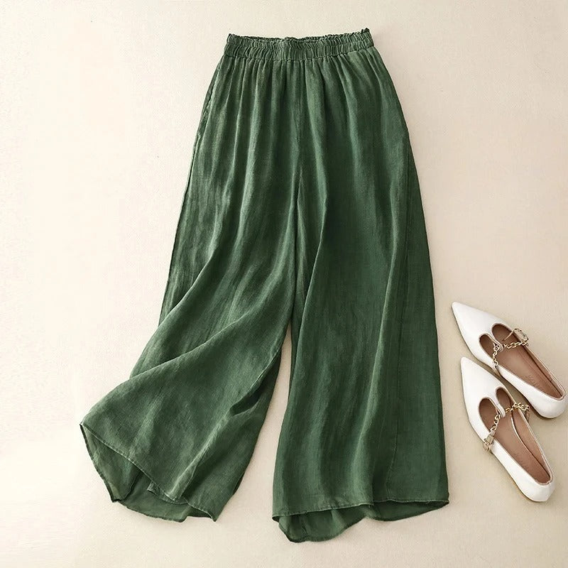 Elegant wide-leg pants for women shown on a plain beige background.