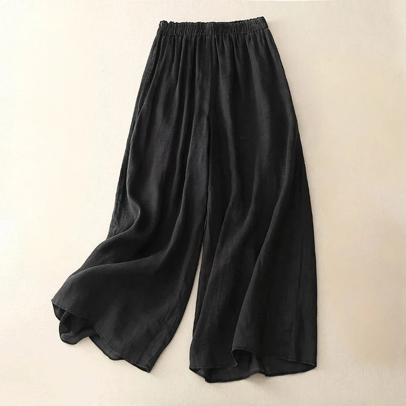Women’s refined loose-fit pants displayed against a beige studio background.
