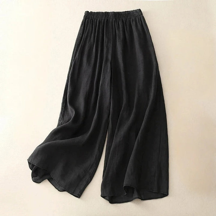 Women’s refined loose-fit pants displayed against a beige studio background.