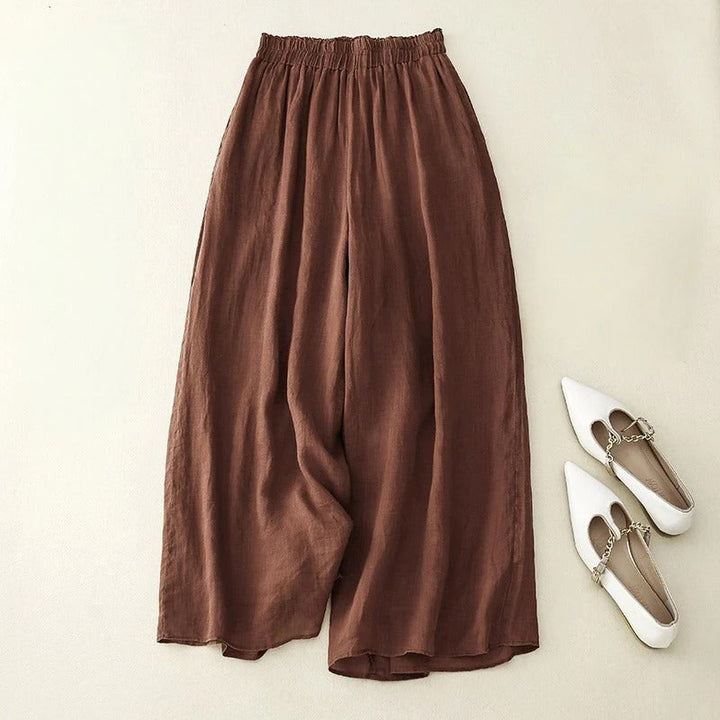 Women’s loose waistband pants displayed on a beige background with a flowing wide-leg design.