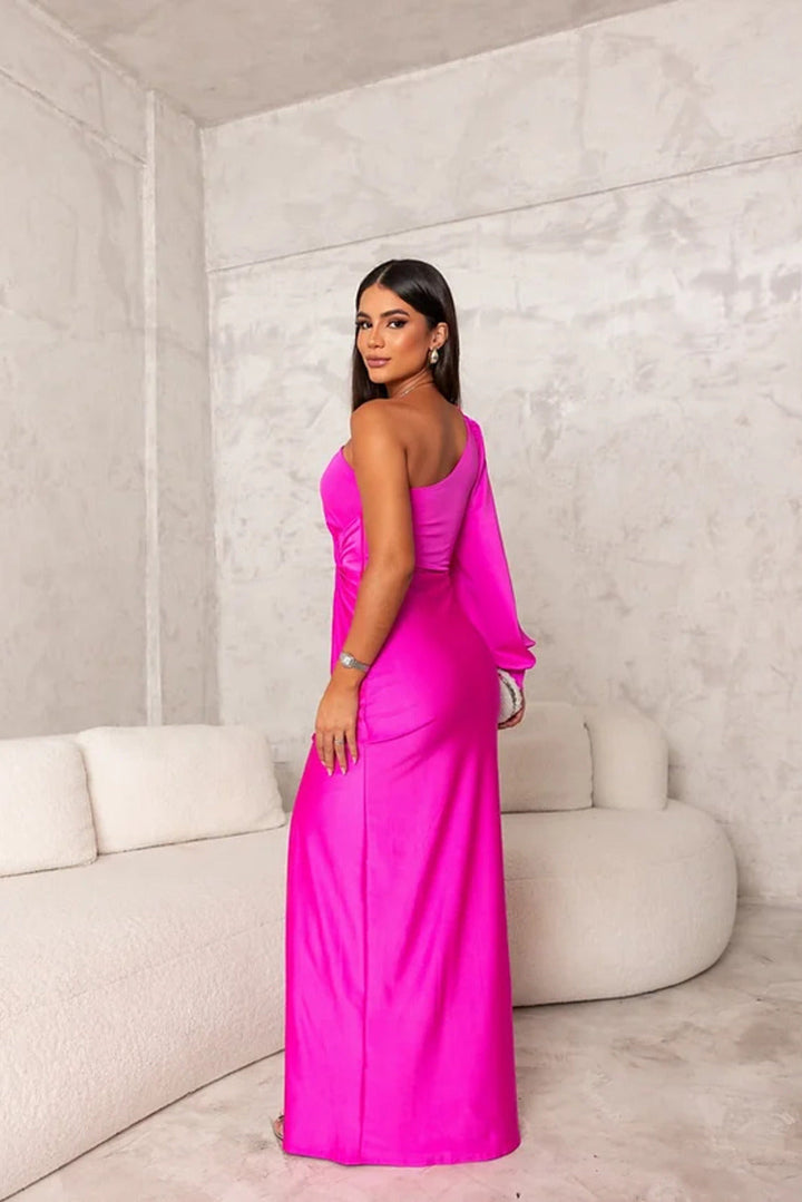 Female model wearing a chic flowing maxi dress against a clean background.