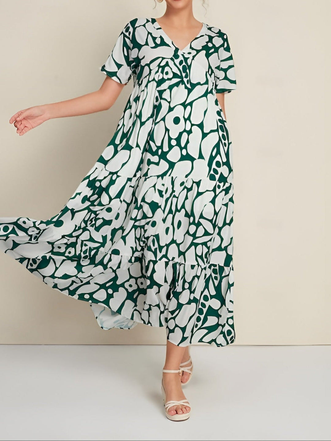 Woman wearing a lightweight summer dress on a plain background.