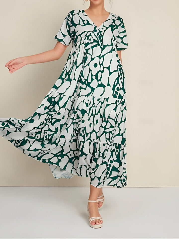 Woman wearing a lightweight summer dress on a plain background.