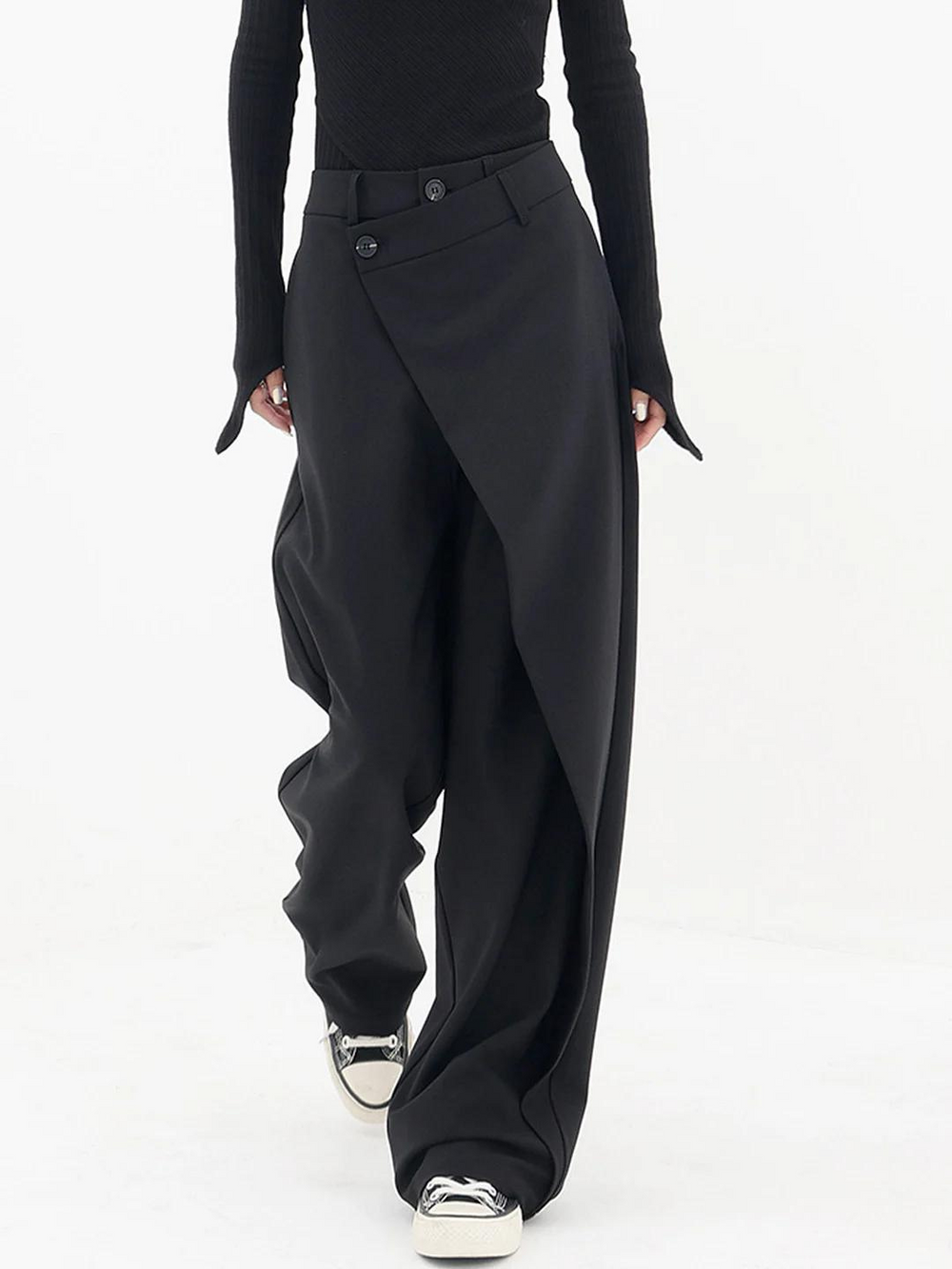 Loose women’s pants with a clean tailored shape on a plain background.