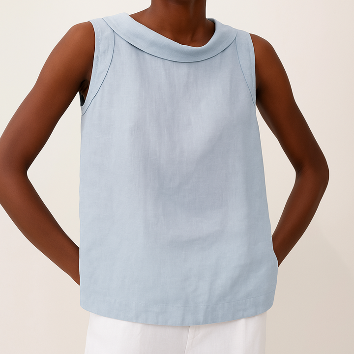 Women’s relaxed draped sleeveless top shown on a person in a plain background setting.