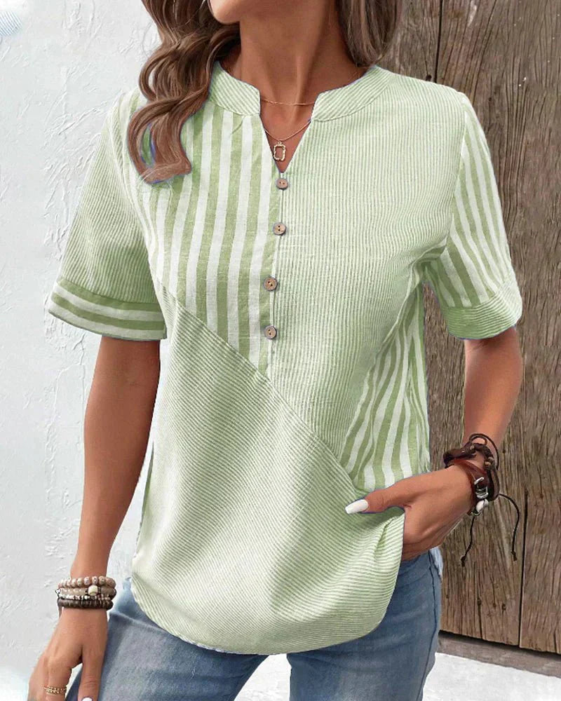 Refined striped blouse styled with a wearer and clean background.