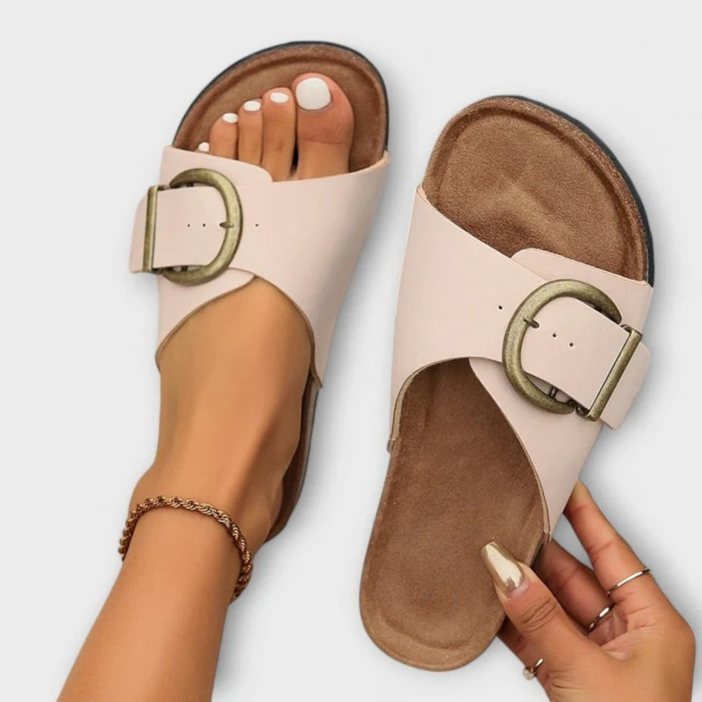Casual sandals with cushioned soles on a plain background.