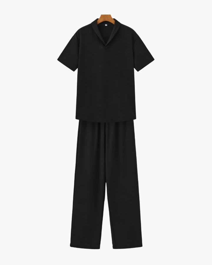 A casual short sleeve V-neck shirt and matching pants on a plain background.e