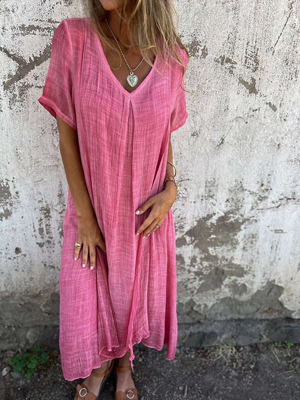 Woman posing in a chic long dress with lightweight breathable fabric.