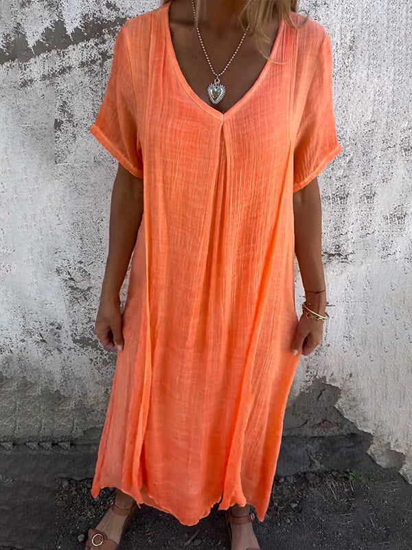Modern women’s maxi dress with soft flowing design against a plain backdrop.