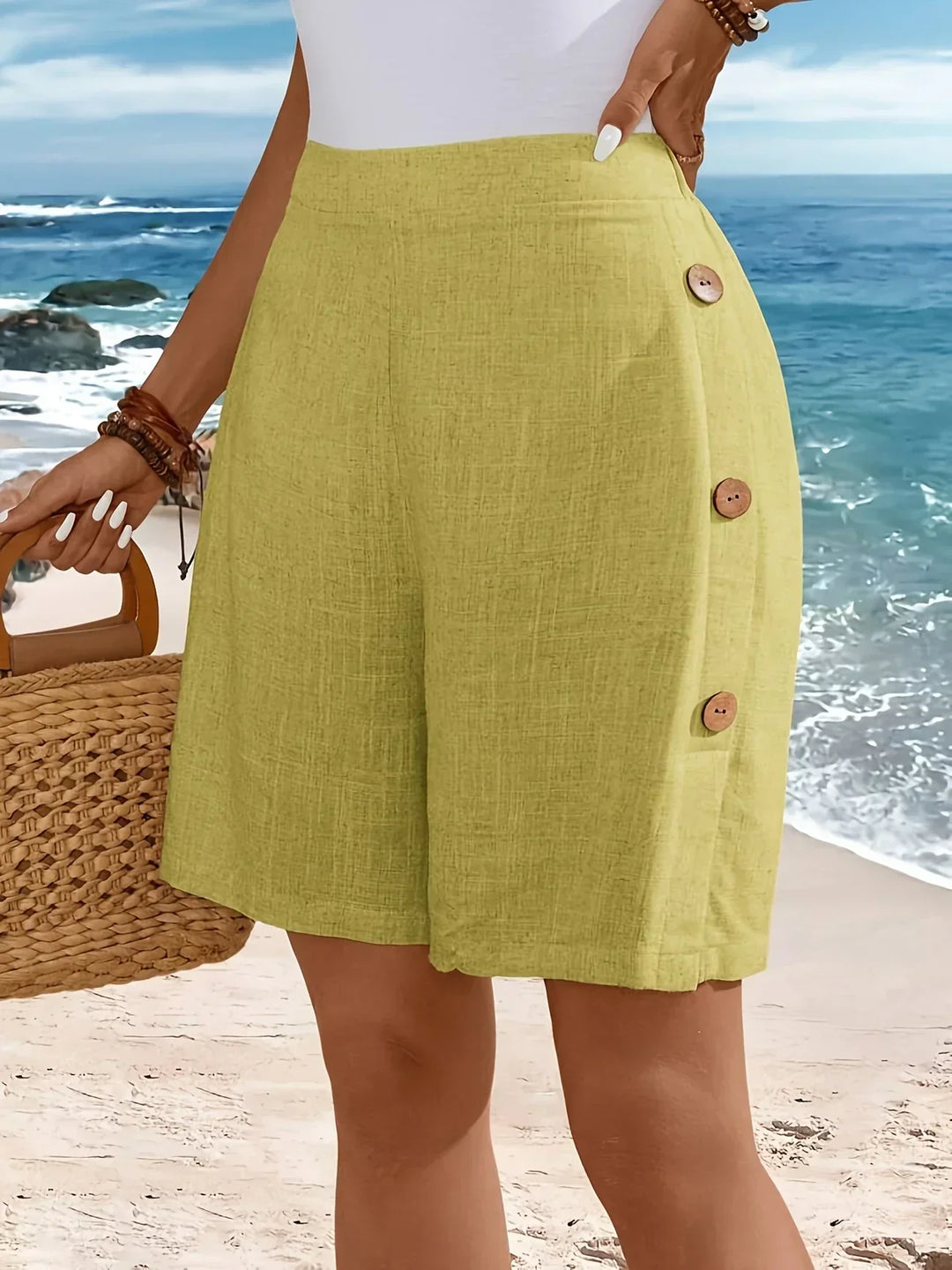 Female model in lightweight button-front shorts on a plain studio background.