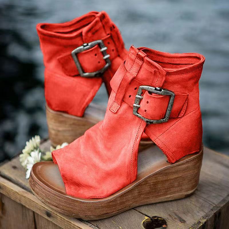 Open-toe wedge sandals with secure buckle closure on a plain background.