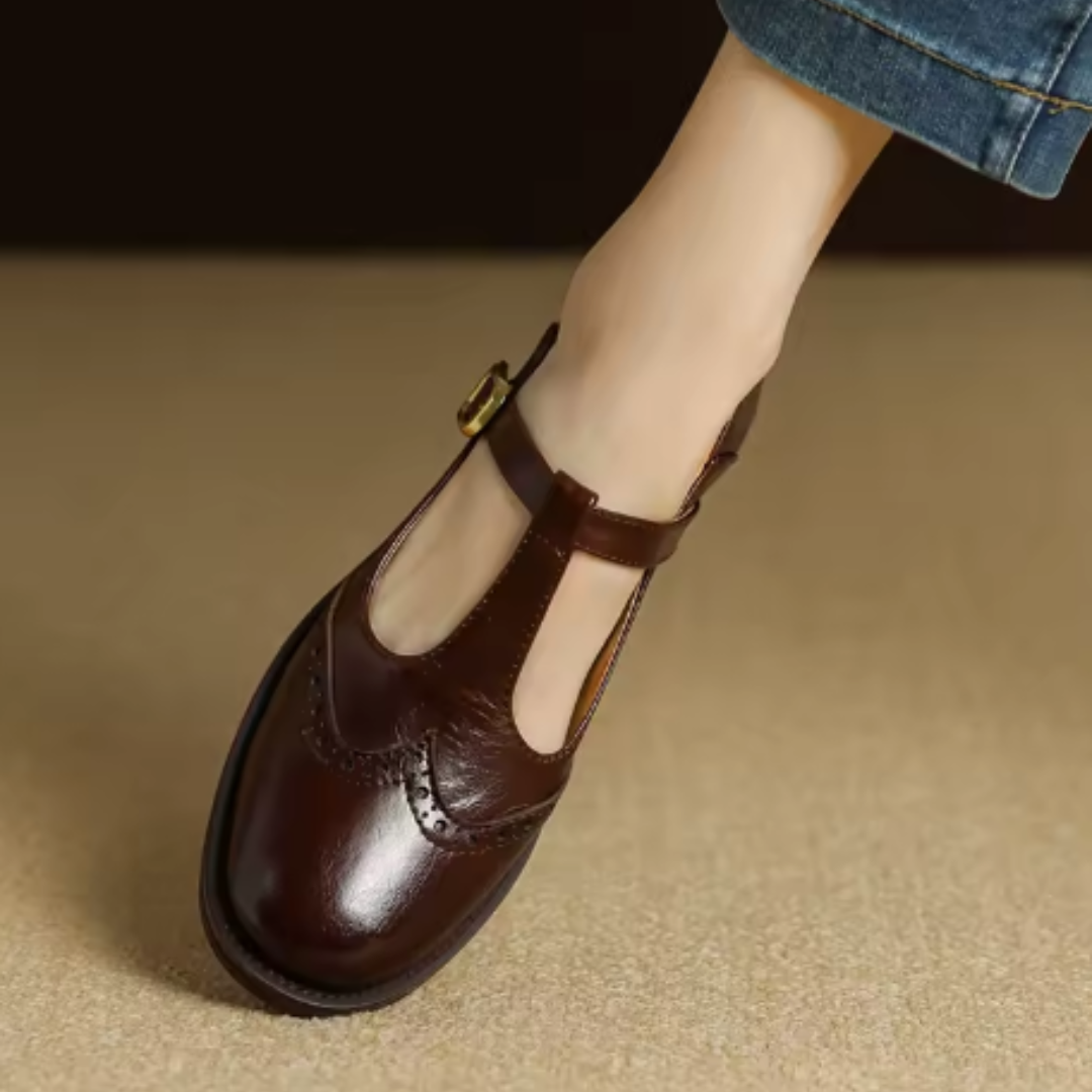 Female model posing in woven slip-on flats on a plain background.