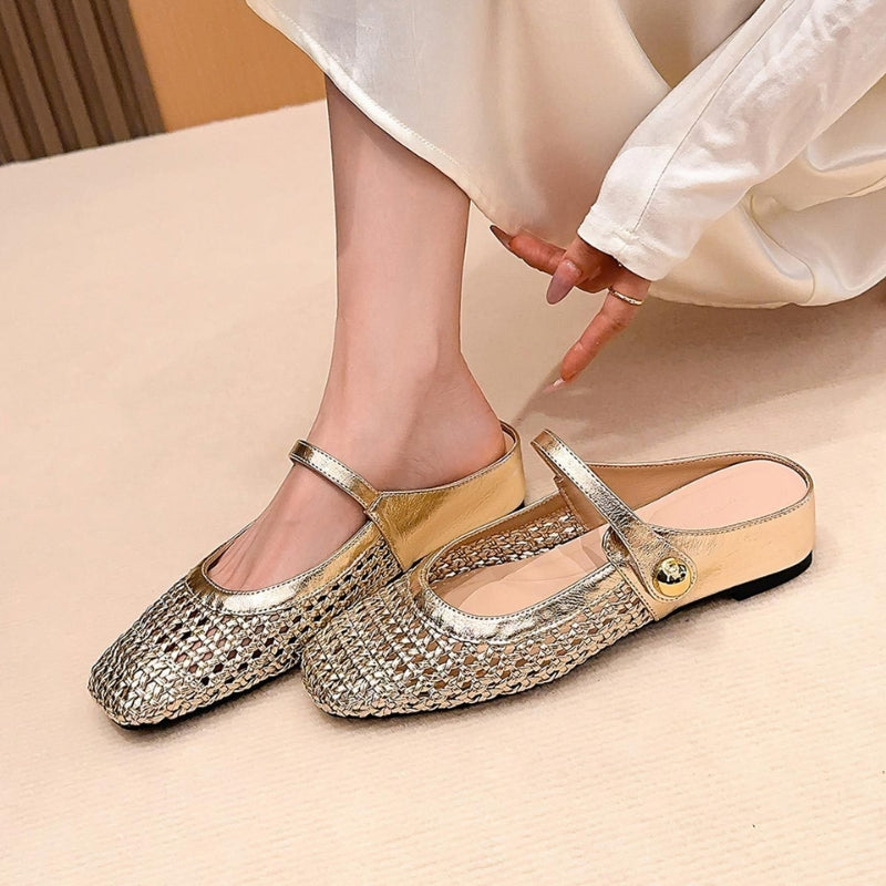 Female model wearing woven flat mules with square toe design on a plain background.