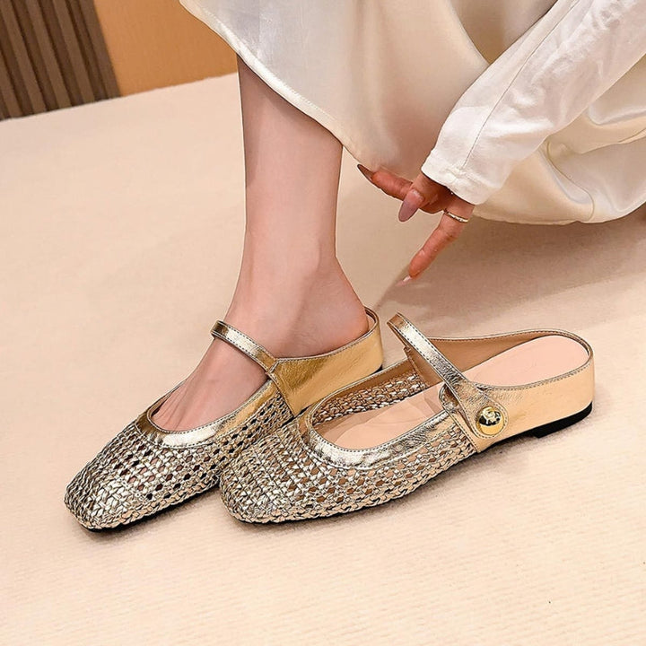 Female model wearing woven flat mules with square toe design on a plain background.