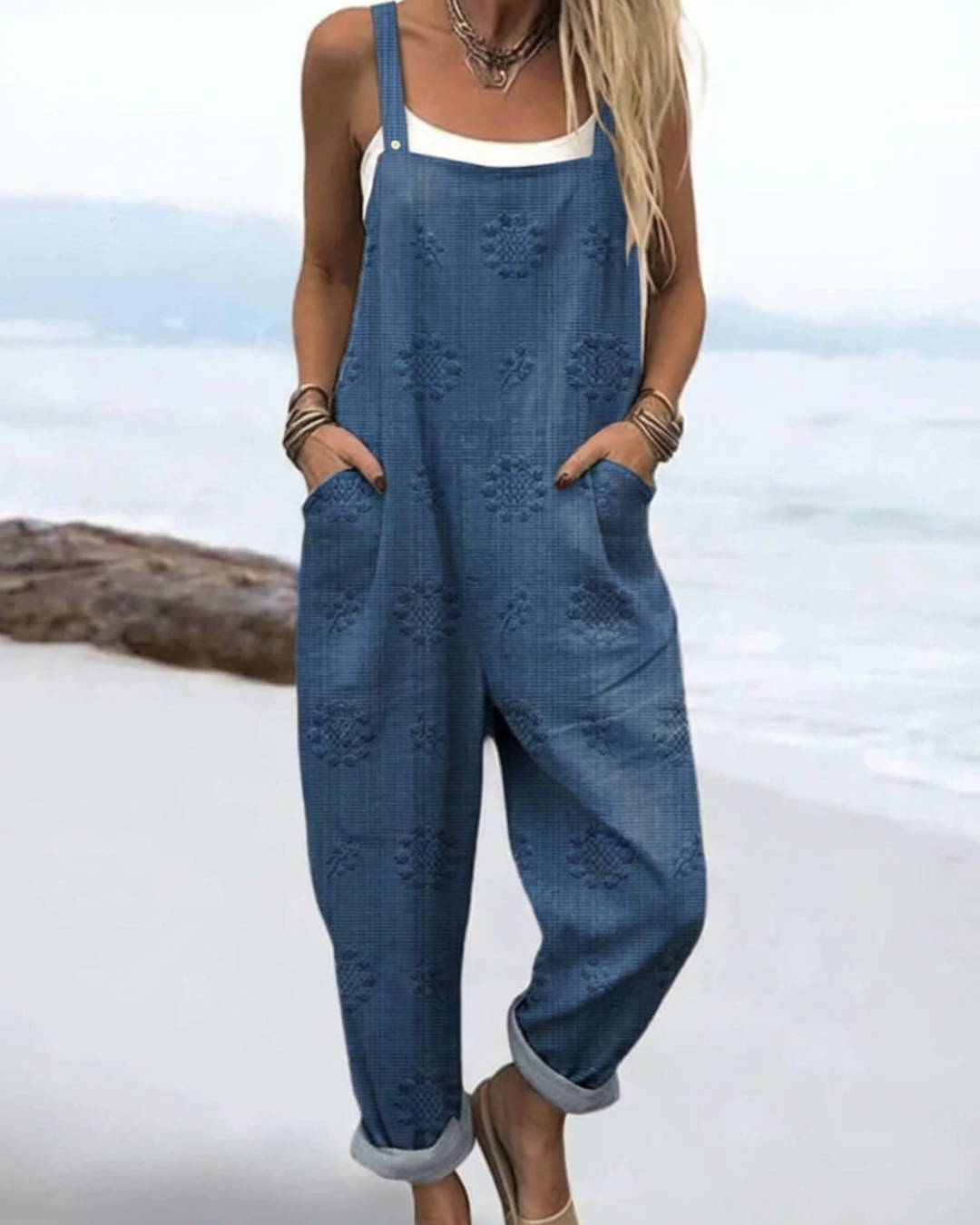 Sleeveless floral jumpsuit displayed on a female model with a clean background.