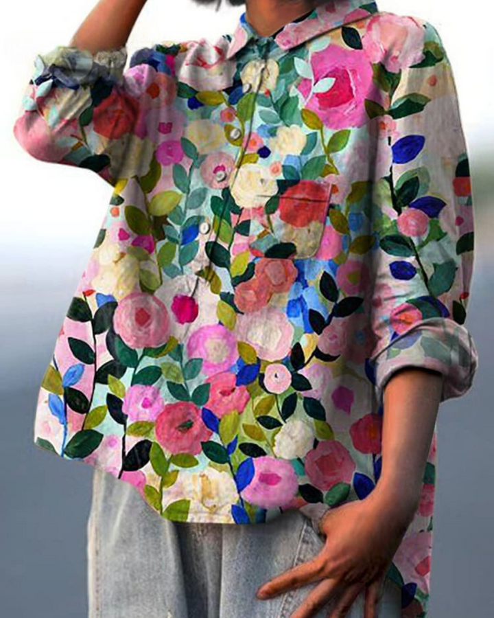 Delicate floral print blouse against a plain background.